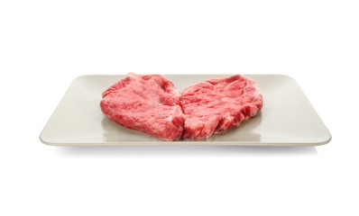 Plate with fresh raw meat, isolated on white
