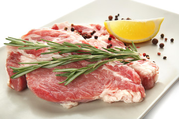 Plate with fresh raw meat, isolated on white