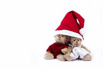 Plush bears wearing Santa hat, isolated on white background