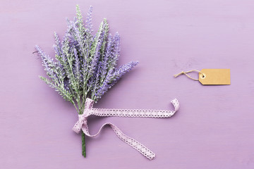 Lavender flower on purple wooden background.
