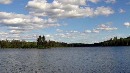 Wonderful view of blue sky with white clouds and still lake on a summer day