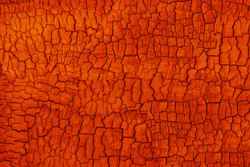 Abstract orange grunge background. Burbed wood texture with cracks