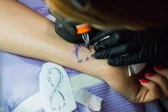  feminine wrist while doing tattoo closeup