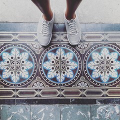 Feet on patterned tiles