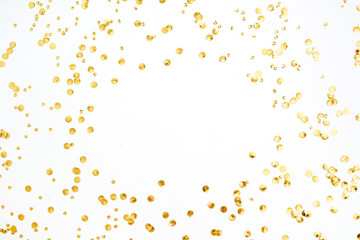 Mock up frame with space for text made of golden confetti tinsel on white background. Flat lay, top view. Minimal background.