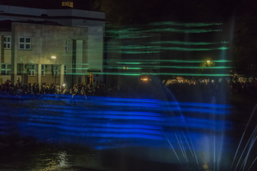 Night laser show with fountaine on river