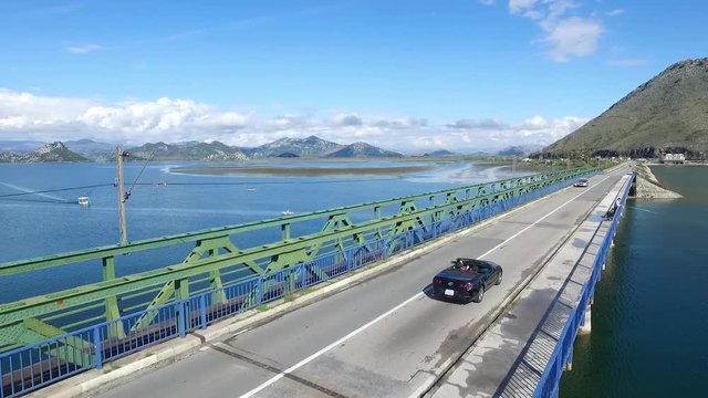 Car drive on beautiful ocean road. Footage. Car driving near with motion blur showing rapid movement on a highway road at Lake.