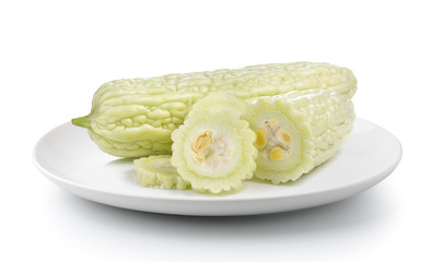 bitter melon in a plate isolated on a white background