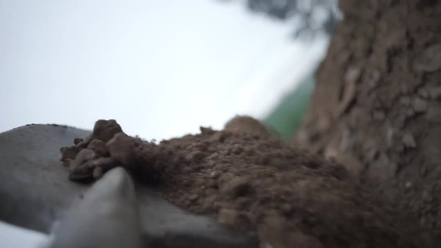 To dig in the Shovel. Footage. Soil with shovel view of a shovel. Close-up, shallow DOF. Digging spring soil with shovel