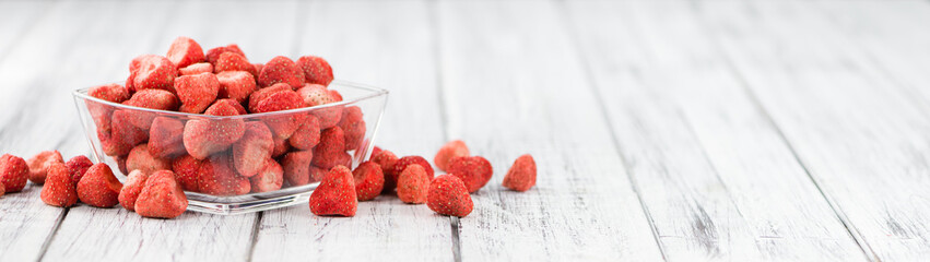 Portion of Strawberries (dried) on wooden background, selective focus