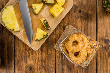 Fresh made Pineapple rings (dried) on a rustic background