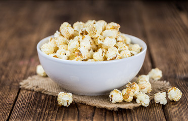 Popcorn on wooden background; selective focus