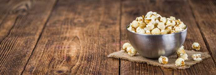 Popcorn on wooden background; selective focus