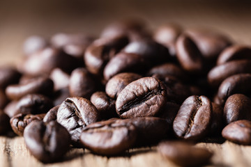 Roasted coffee beans on wooden background.