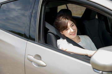 young woman sitting on seat of motor vehicle.