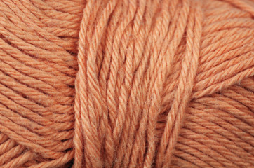 A super close up image of orange yarn