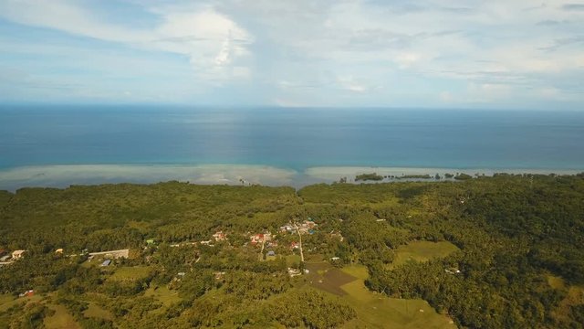 The town near the sea, houses, buildings, port. Aerial view coastal city nn the island of Bohol near the sea. Seascape with a town and the sea. 4K video. Travel concept. Aerial footage.