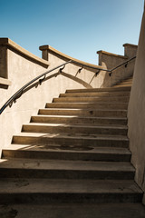A stone staircase with handrail leads upward