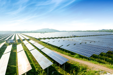 Photovoltaic modules reflect sunset light and clouds