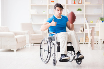 Young man american football player recovering on wheelchair