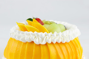 colorful fruit birthday cake isolated on white background