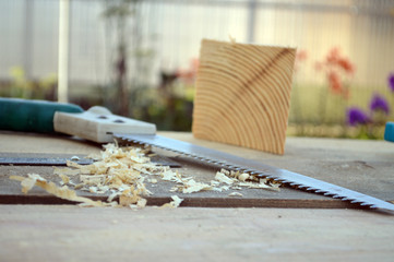 saw and wooden shavings on the boards