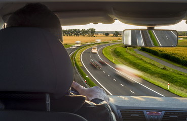 view from the inside of a car driving a busy highway, view from the driver's position