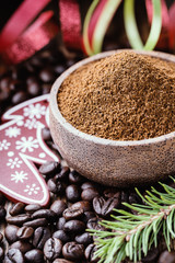 Whole and ground coffee beans  with christmas decorations.