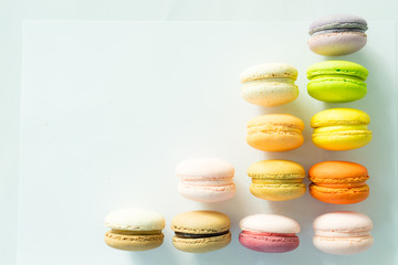 Colorful macarons like graph increasing on white backgound, selective focus