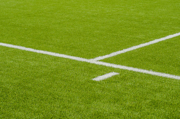 Obraz premium The white Line marking on the artificial green grass soccer field