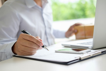 Teenager owner work at home for online shopping checking order product with office equipment