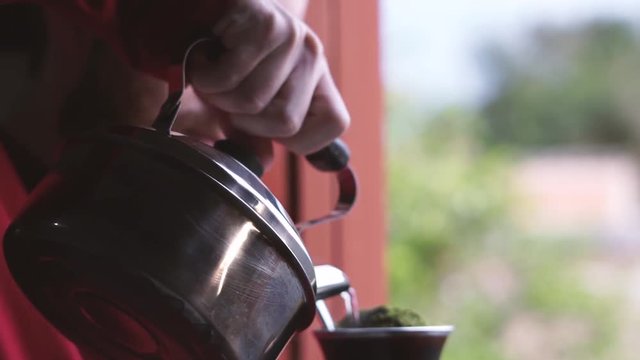 Homem servindo e bebendo mate amargo - Rio Grande do Sul, Brasil.