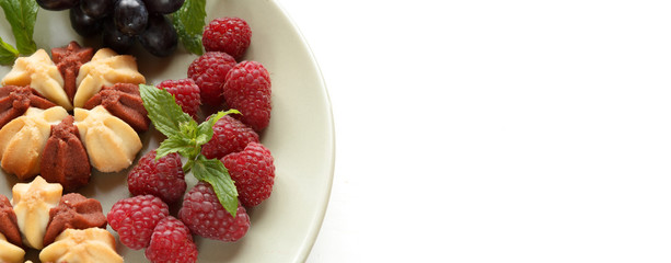 Biscuit with fresh berries on white plate. Selective focus. Copy space
