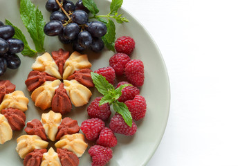 Biscuit with fresh berries on white plate. Selective focus. Copy space