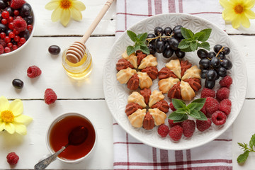 Biscuit with fresh berries on white plate. Selective focus.