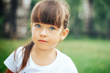 little beautiful cute girl looking at camera blue eyes