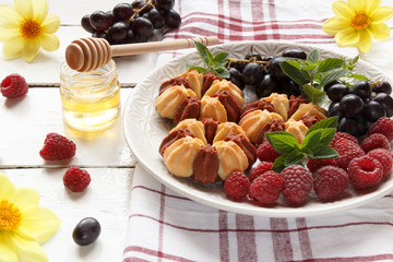 Biscuit with fresh berries on white plate. Selective focus.