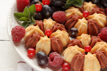 Biscuit with fresh berries on white plate. Selective focus.