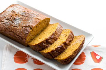 Pumpkin cake loaf slices. Pumpkin bread is a thick sweet cake loaf made with pumpkins. Typically baked in Fall season, it is the perfect halloween food as you can use Jack O'Lantern carving leftovers!