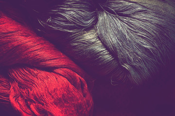 closeup of red and blue silk fabric thread for background, vintage style.