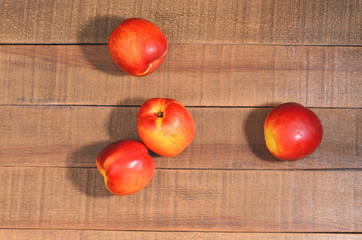 Ripe delicious Nectarines on a wooden background