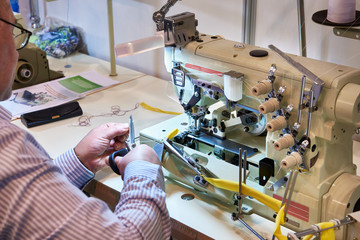 Tailor at work with sewing machine