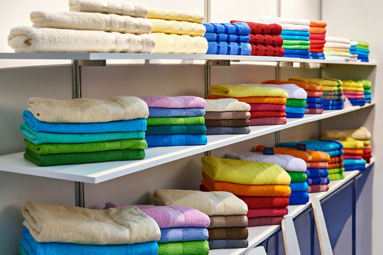 Colored terry towels on shop shelves