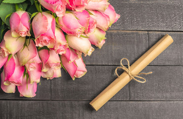 Bouquet of roses and letter scroll