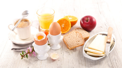Obraz na płótnie Canvas breakfast with egg, orange juice and coffee cup