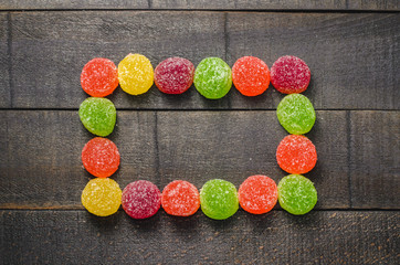 Bright colored candy, sweets, sweets on a dark background, top view