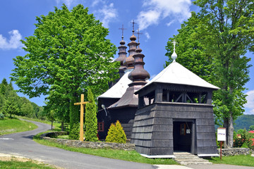 Ancient greek catholic wooden church in Banica, Beskid Niski,Poland - obrazy, fototapety, plakaty