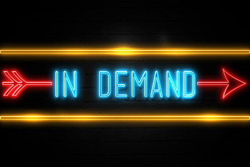 Fototapeta premium In Demand - fluorescent Neon Sign on brickwall Front view