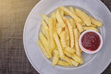 Top View French fries on plate with ketchup , light effect.