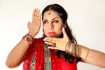 Woman dancing Indian dance in national dress. A handsome beautiful girl portrait in red Hindu...